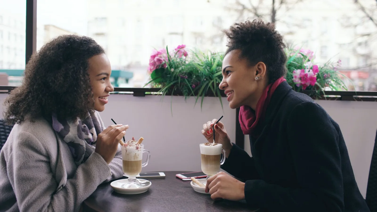 Twee vrouwen in een ontspannen gesprek in een lichte ruimte