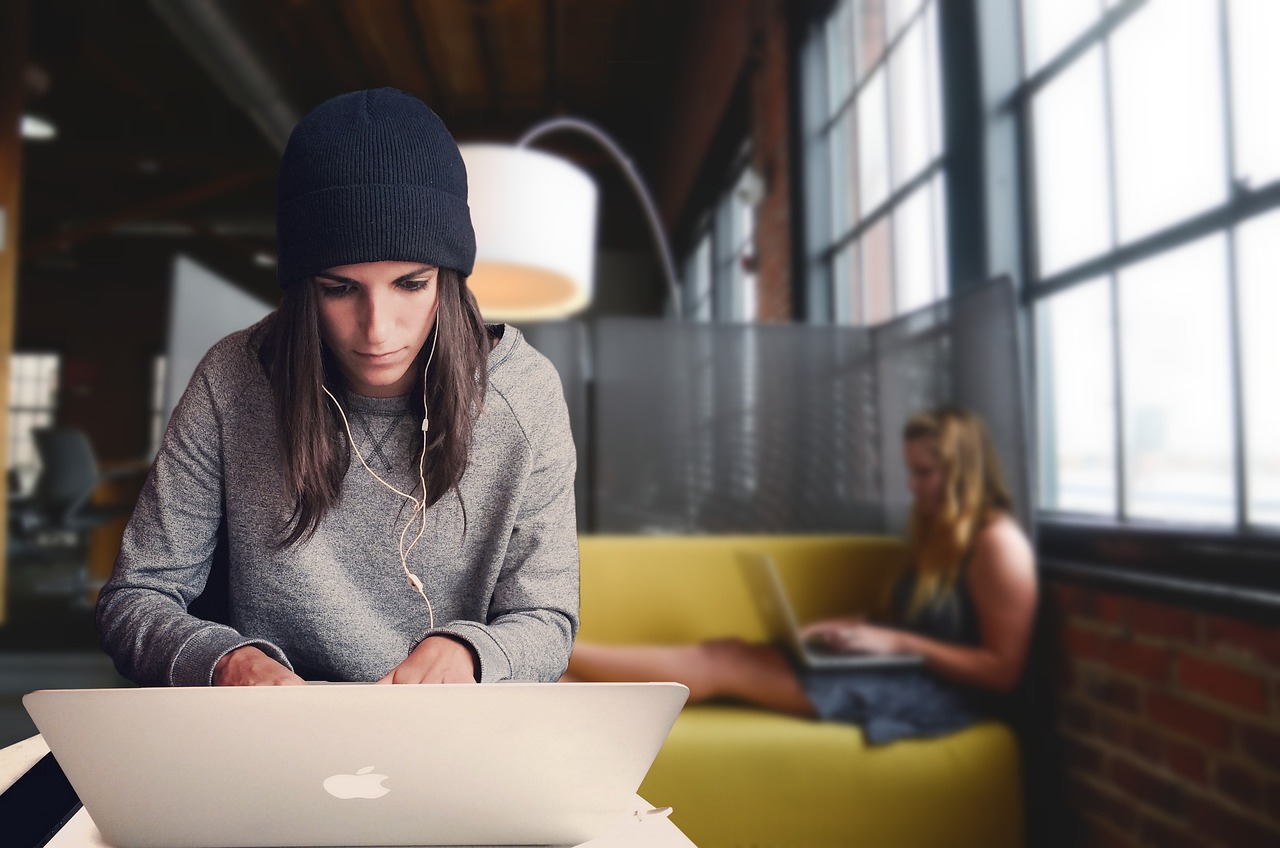 Vrouw werkt aan een ondernemersplan met laptop en notitieboek
